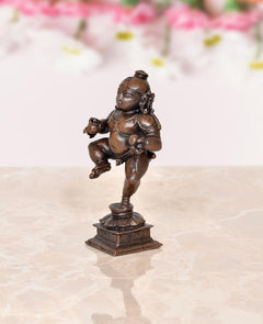 Copper Bal Krishna dancing figurine, 3.5 in, side angle on pedestal
