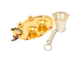 Decorated Holi plate with two brass bowls, pichkari handle, and silver cup