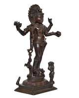 Brass-toned Bhikshatana Shiva idol, angled view showing raised arm and small holding figure
