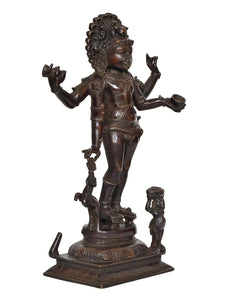 Brass-toned Bhikshatana Shiva idol, angled view showing raised arm and small holding figure