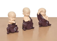 Purple resin monk Buddha figurines with prayer hands, seated, three-quarter angle