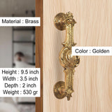 Brass door handle pair, golden finish, round backplates with scrollwork