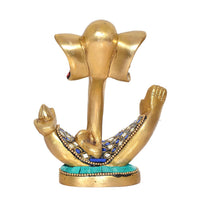 Brass Ganesha idol from back angle with gold raised hands and blue jewel trim on base