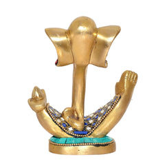 Brass Ganesha idol from back angle with gold raised hands and blue jewel trim on base