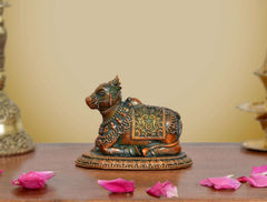 Nandi seated brass statue with colorful inlay designs and textured round base