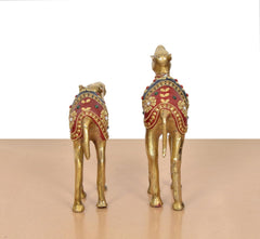 Back view brass camel figurines, red decorated saddle panels with gold trim