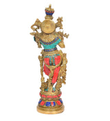 Brass Krishna idol figurine with ornate halo wheel and teal red clothing, profile view