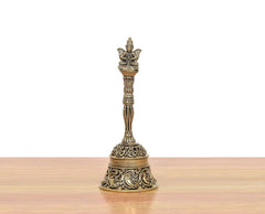 Bronze pooja bell with Garun on top; carved bell base and slender stem.