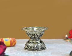 Brass aarti diya oil lamp, side view showing engraved base and open top bowl