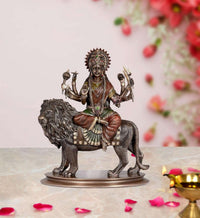 Durga statue on lion with gold-toned crown and multicolour decorative garments