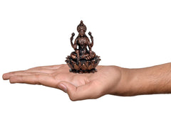 Copper Laxmi Maa statue on open palm, seated on lotus base, 3.5 in