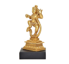 Dancing Bal Krishna brass statue from side view, coiled-leg stance, black pedestal