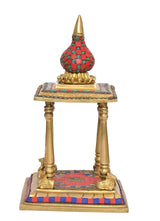 Front view brass pooja mandir with gold posts, red floor, and blue-green border details
