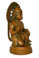 Brass Hanuman idol statue, profile view with curved halo and draped ornaments