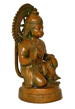 Brass Hanuman idol statue, profile view with curved halo and draped ornaments
