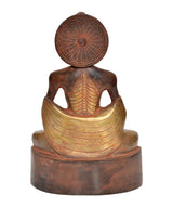 Brass Buddha statue from rear, seated figure with radiating halo and ribbed torso.