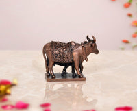 Copper cow and calf pooja mandir figurine, front-left view, carved metal finish