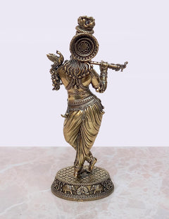 Brass Lord Krishna idol rear view, headdress and halo details with round base.