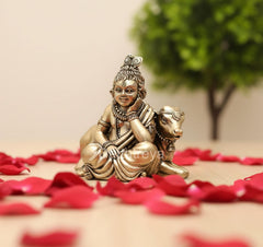 Brass Lord Bal Gopal with cow idol, seated on base, side view
