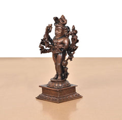 Copper Kal Bhairav idol, side view with crown and raised hand, detailed pedestal base