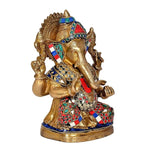 Brass Ganesha statue idol side view with jeweled headpiece and ornate jewelry