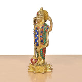 Brass Vishnu idol side view, jeweled blue sash, red and green enamel borders, lotus base.