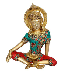 Front view of brass Indra Devta statue, gold face, teal and red jeweled clothing, seated.