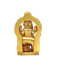 Back view of brass Trimurti idol with seated form and decorative halo, 3.3 in