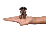 Small copper Lakshmi Narasimha statue held in hand, seated figure with canopy, 2-inch