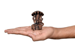 Small copper Lakshmi Narasimha statue held in hand, seated figure with canopy, 2-inch