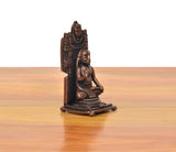 Copper guru idol figurine, seated hands in prayer pose, angled side view.