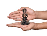 Copper Surya Dev Rath miniature statue in hands, front view, ornate seven-horse base