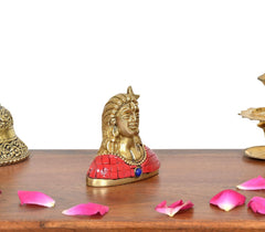 Brass Adiyogi Shiva idol angled view, red robe with blue medallion at center