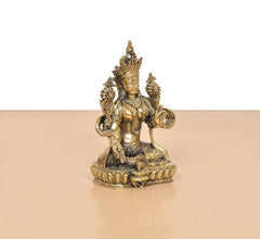 Brass Tara Devi statue, angled view of seated figure with embellished base and jewelry