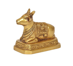 Brass seated Nandi bull statue, side view with ornate engraving on base