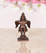 Copper Garuda idol statue, rear view with wing motifs and arched headdress