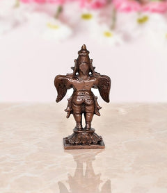 Copper Garuda idol statue, rear view with wing motifs and arched headdress