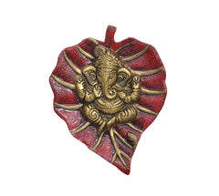 Metal Ganesha wall hanging close-up, heart-shaped red and gold relief figure