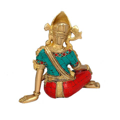 Indra brass idol side view, teal and red beaded details on seated posture