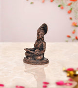 Annapurna copper decorative showpiece, side view of seated goddess with raised hand