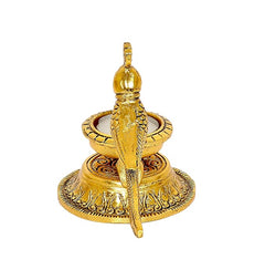 Gold metal parrot diya statue with candle, front view on circular patterned base