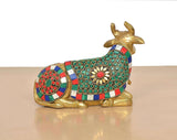 Brass seated Nandi statue rear view, striped jeweled blanket with circular medallions