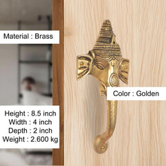 Golden brass Ganesha face door handle with curved lever and visible mounting screws