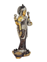 Side view of brass Maa Lakshmi idol statue holding small objects in hands