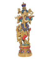 Brass Krishna idol figurine with crown, flute, blue and red jeweled outfit, standing view