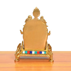 Brass pooja chowki back view, smooth gold panel with multicolor base trim and feet