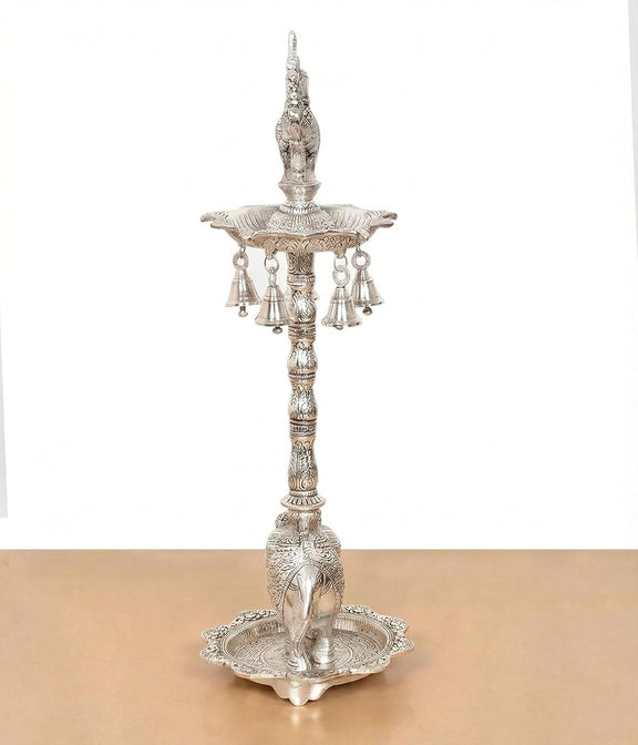 Silver metal peacock oil lamp stand with central pillar and hanging bell cups