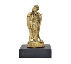 Golden back/side view of standing deity idol with crown, on black base