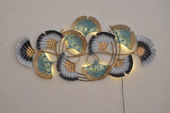 Iron botanical wall hanging with illuminated filigree leaves, teal-blue and dark gray