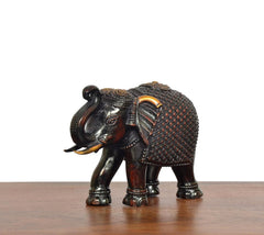 Dark bronze elephant figurine, three-quarter view, patterned torso and ornate head details